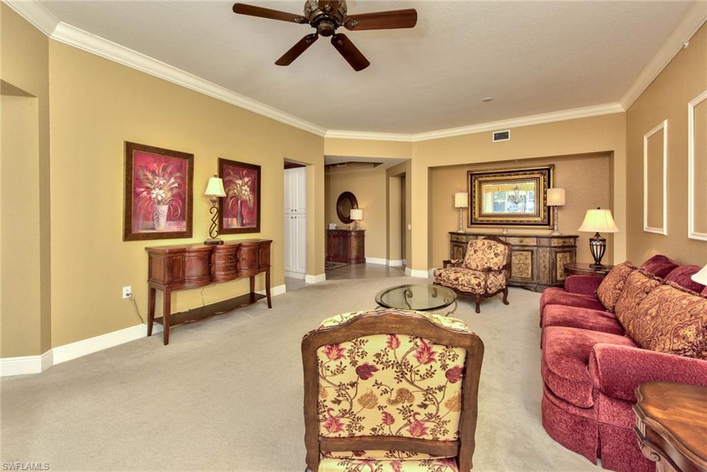 Undisclosed Address Naples, FL 34114 - Photo 3 of 25 a living room with furniture and a flat screen tv