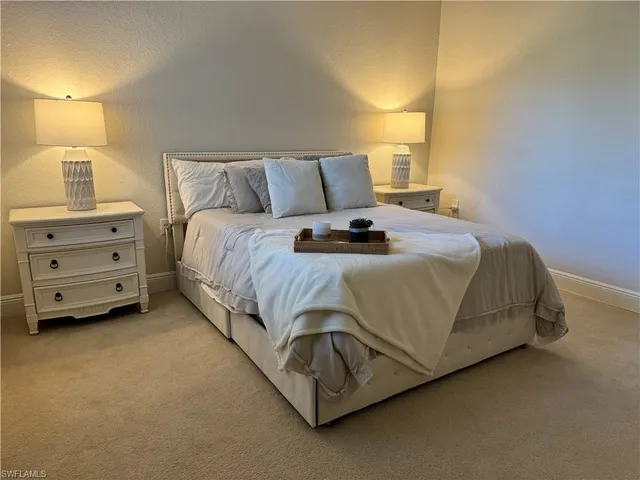 a bedroom with a bed and lamp