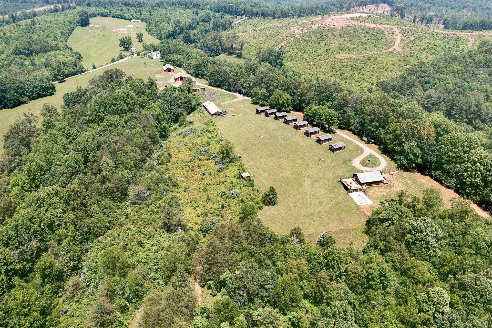 2446 Deer Run Road Ferrum, VA 24088 - Photo 119 of 145 an aerial view of a house with a yard and trees