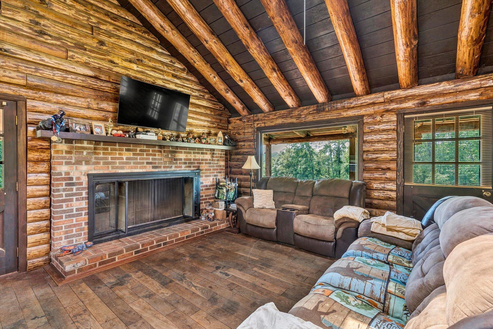 2446 Deer Run Road Ferrum, VA 24088 - Photo 15 of 145 a living room with furniture a flat screen tv and a fireplace