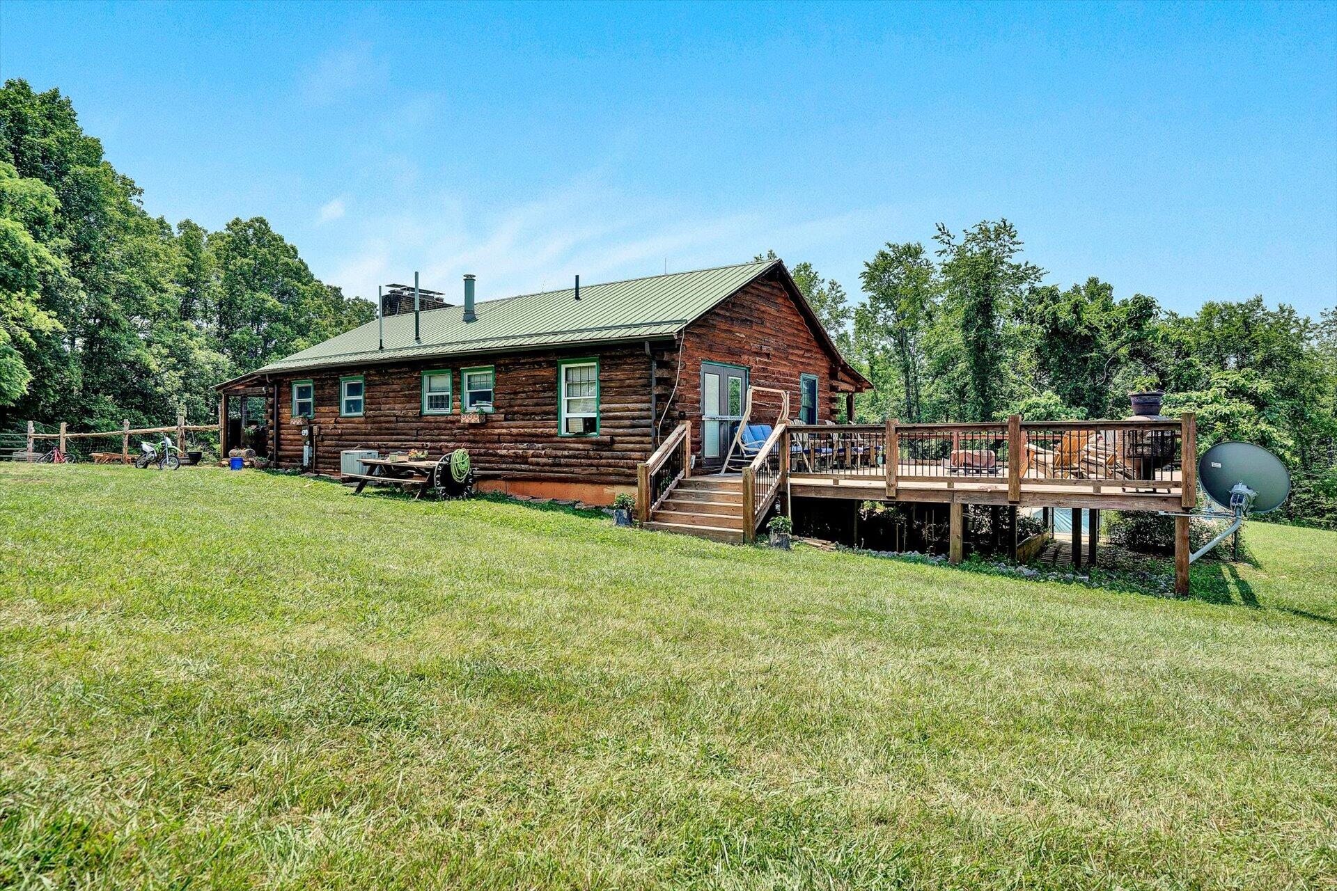 2446 Deer Run Road Ferrum, VA 24088 - Photo 28 of 145 a view of a house with a big yard and sitting area