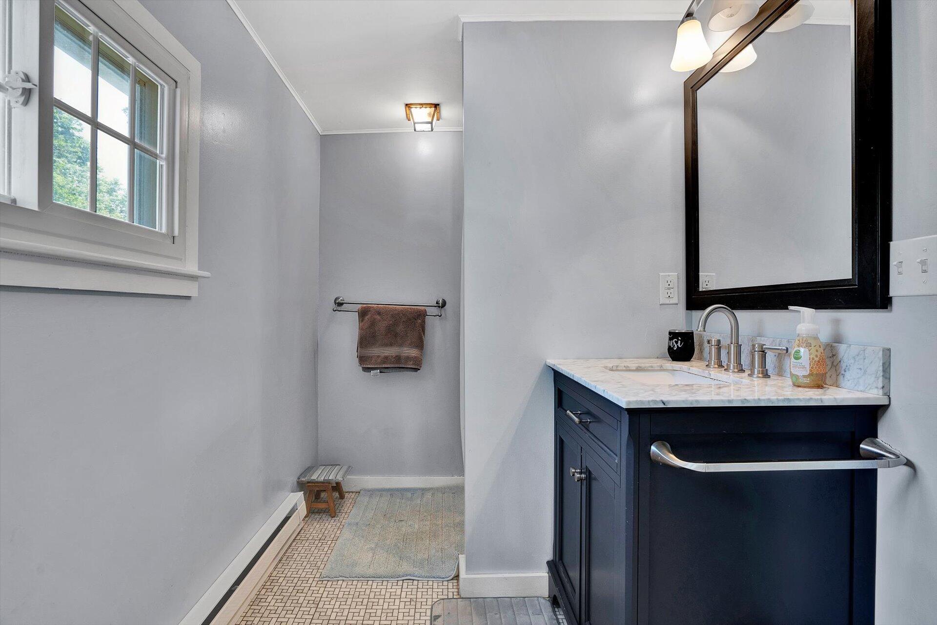 2446 Deer Run Road Ferrum, VA 24088 - Photo 45 of 145 a bathroom with a sink and a mirror