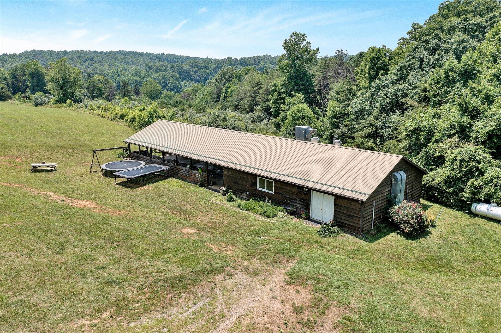 2446 Deer Run Road Ferrum, VA 24088 - Photo 73 of 145 a view of a white house with a yard and sitting area