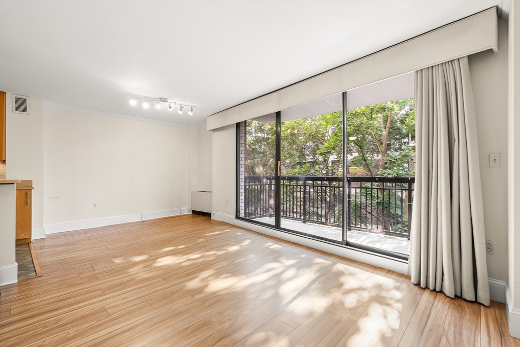 50 Longwood Avenue, Unit 518 Brookline, MA 02446 - Photo 13 of 33 a view of an empty room with wooden floor and a window