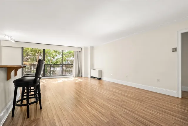 a view of a livingroom with furniture wooden floor and front door