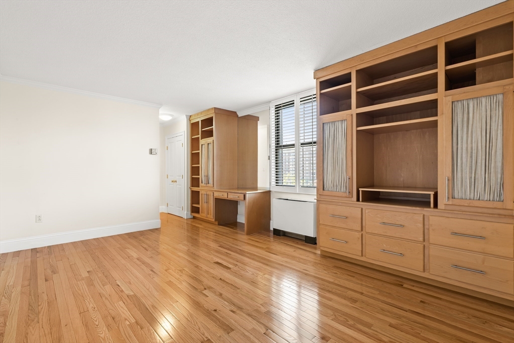 50 Longwood Avenue, Unit 518 Brookline, MA 02446 - Photo 24 of 33 a view of an empty room with wooden floor and windows