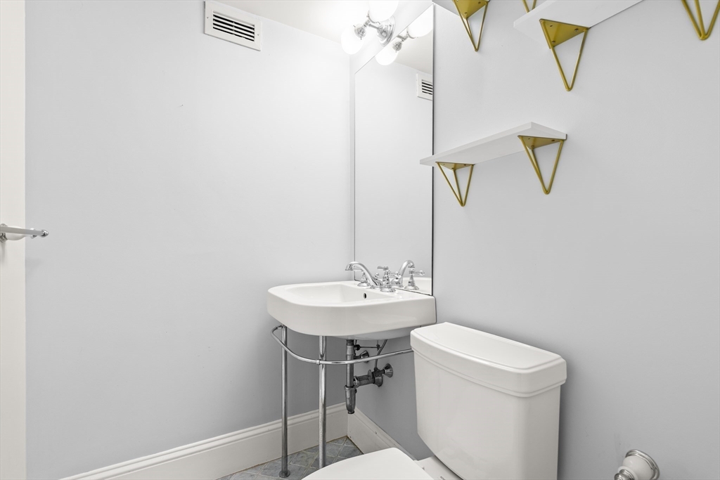 50 Longwood Avenue, Unit 518 Brookline, MA 02446 - Photo 26 of 33 a bathroom with a sink a toilet and mirror