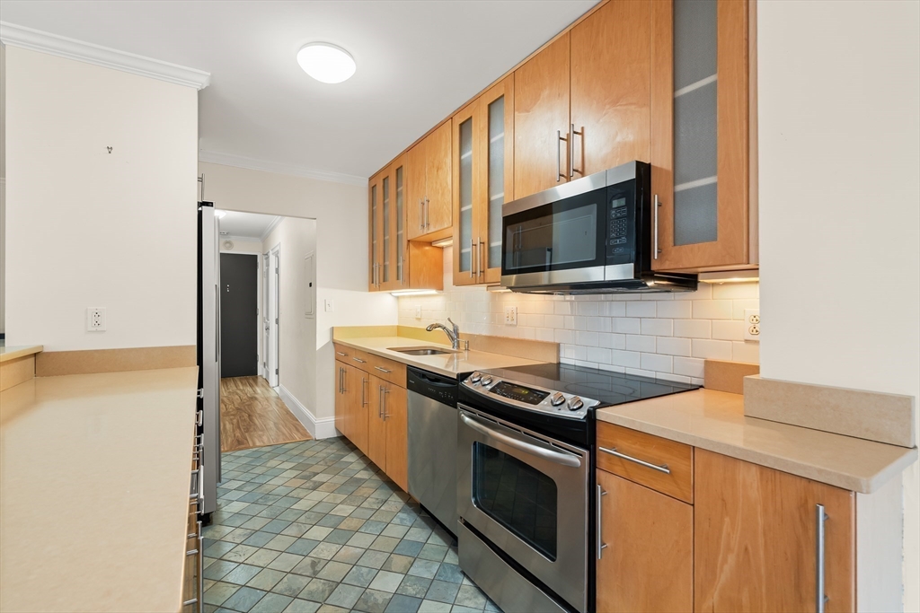50 Longwood Avenue, Unit 518 Brookline, MA 02446 - Photo 7 of 33 a kitchen with stainless steel appliances a stove microwave and refrigerator