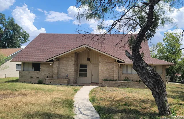 a house with a tree in the background