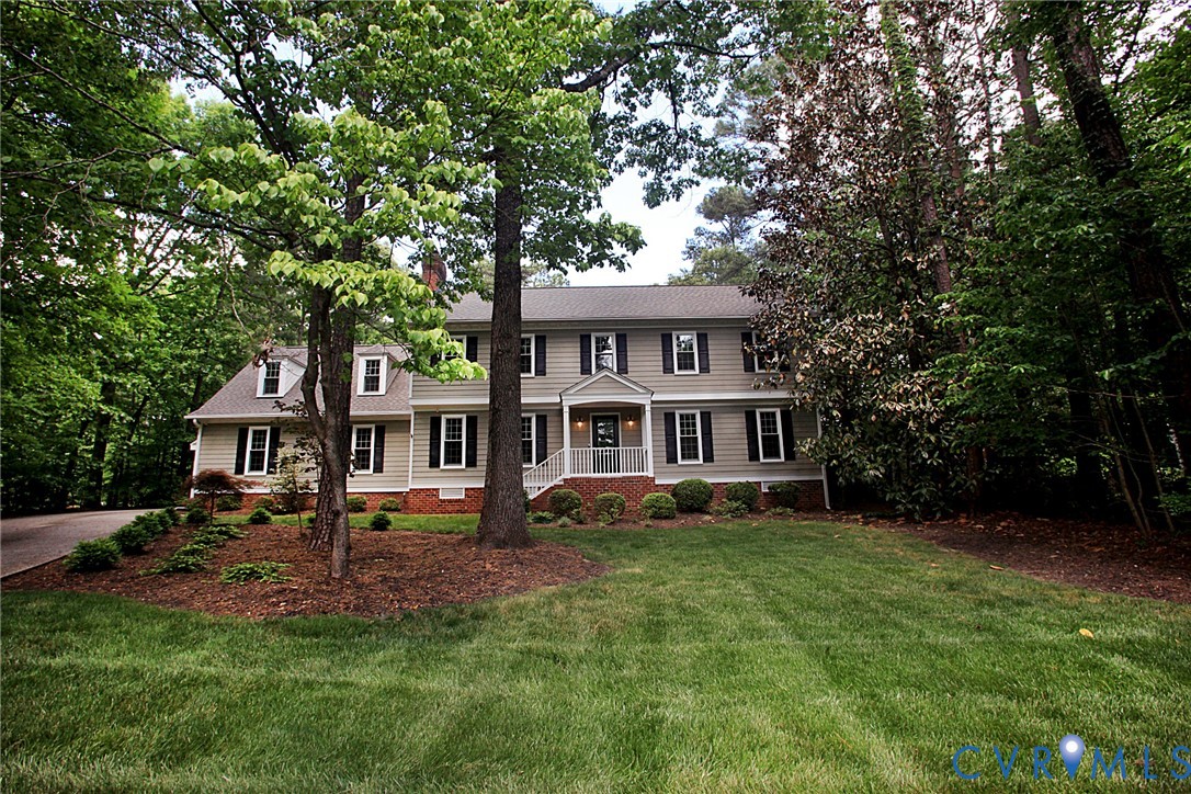 231 Hazelmere Drive Chesterfield, VA 23236 - Photo 3 of 33 a front view of a house with a garden and trees