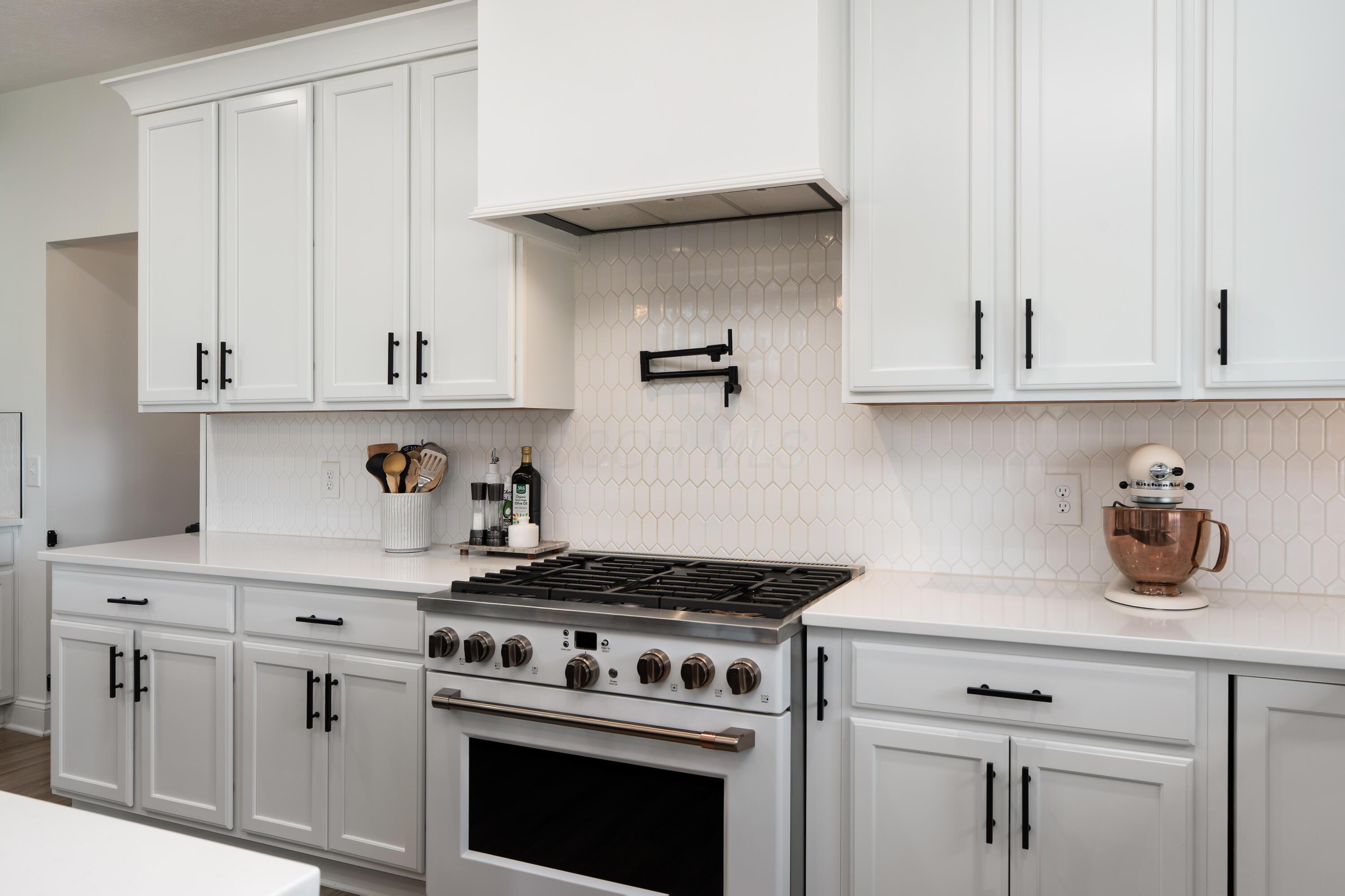 7308 Concord Road Delaware, OH 43015 - Photo 23 of 73 Kitchen with Gas Range with Custom Hood Detail and Tile Backsplash