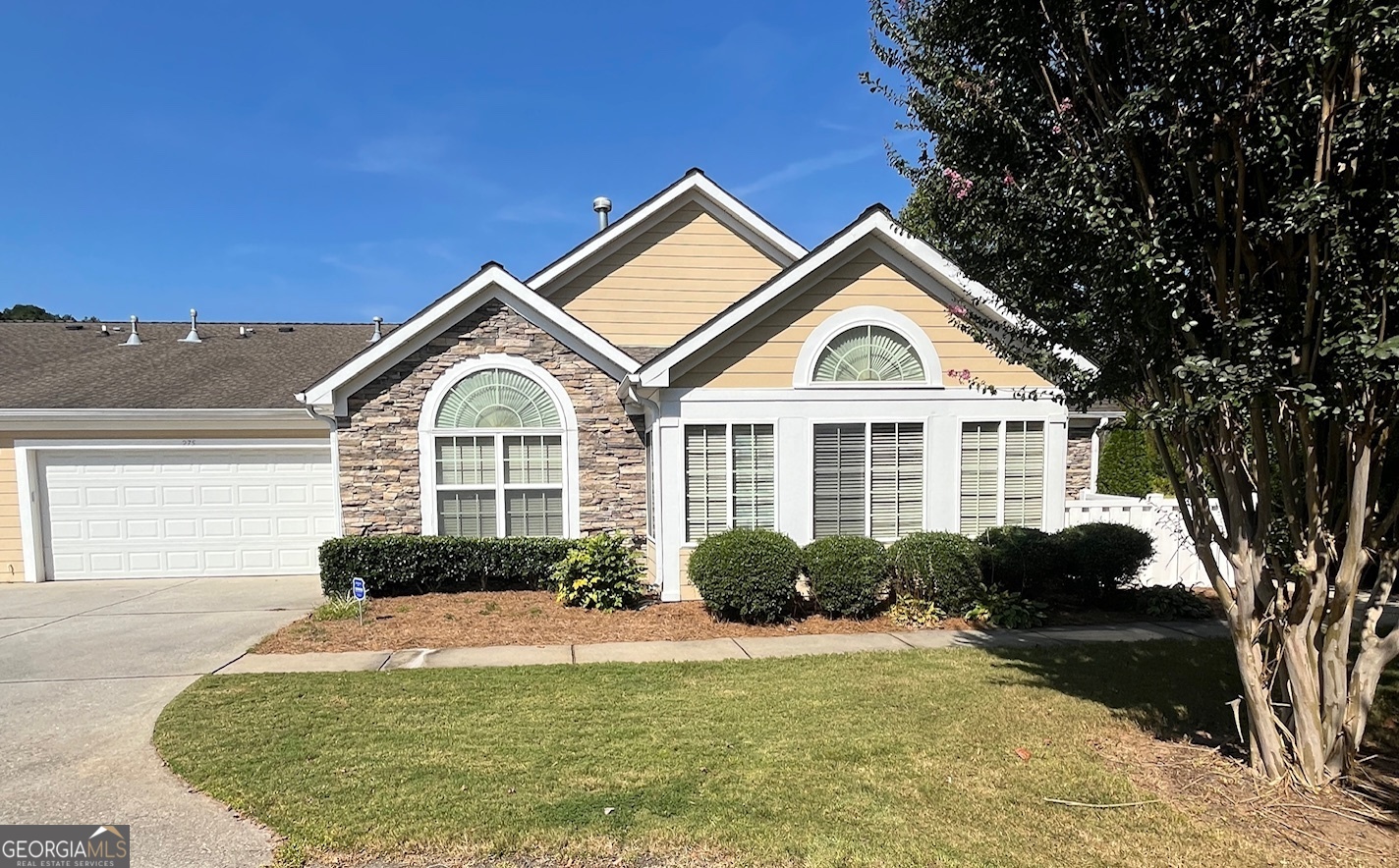 a front view of a house with a garden