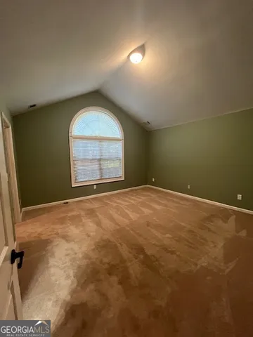 an empty room with a empty space and windows