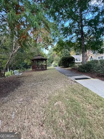 a view of a house with a yard and garage