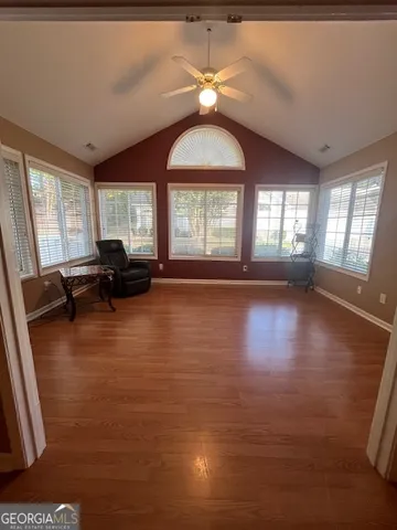 a living room with furniture window and wooden floor