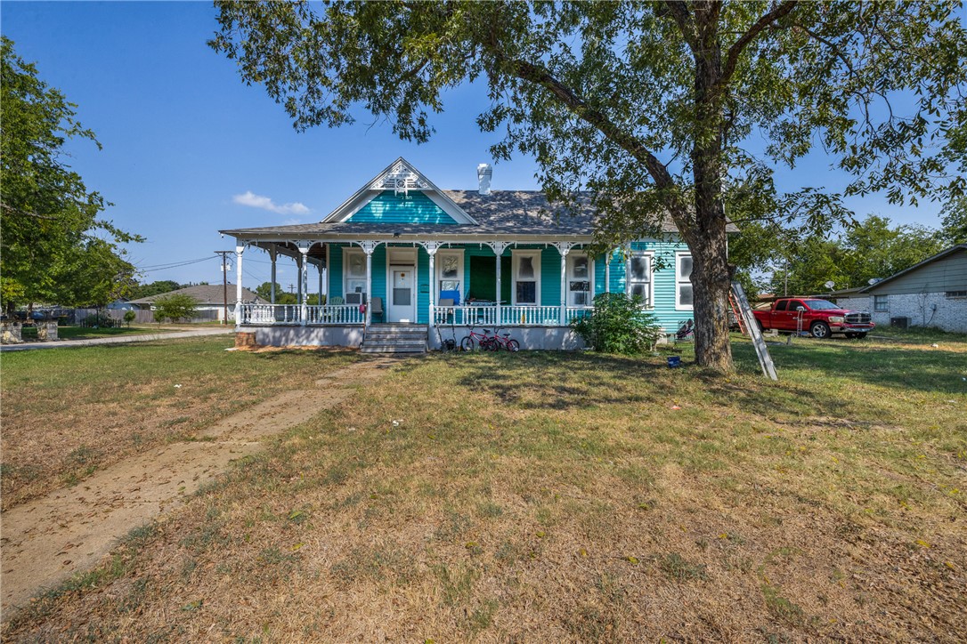 View of front facade featuring a porch and a front lawn