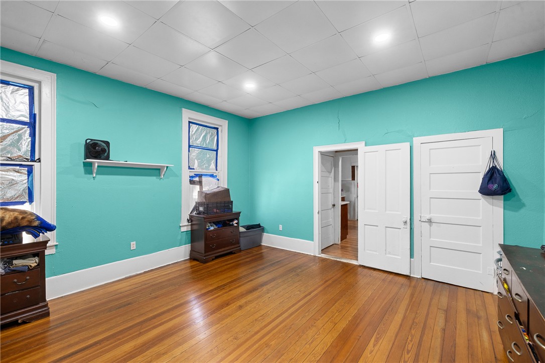 610 West Davis Street Hearne, TX 77859 - Photo 15 of 27 Misc room with light wood-style floors and a drop ceiling