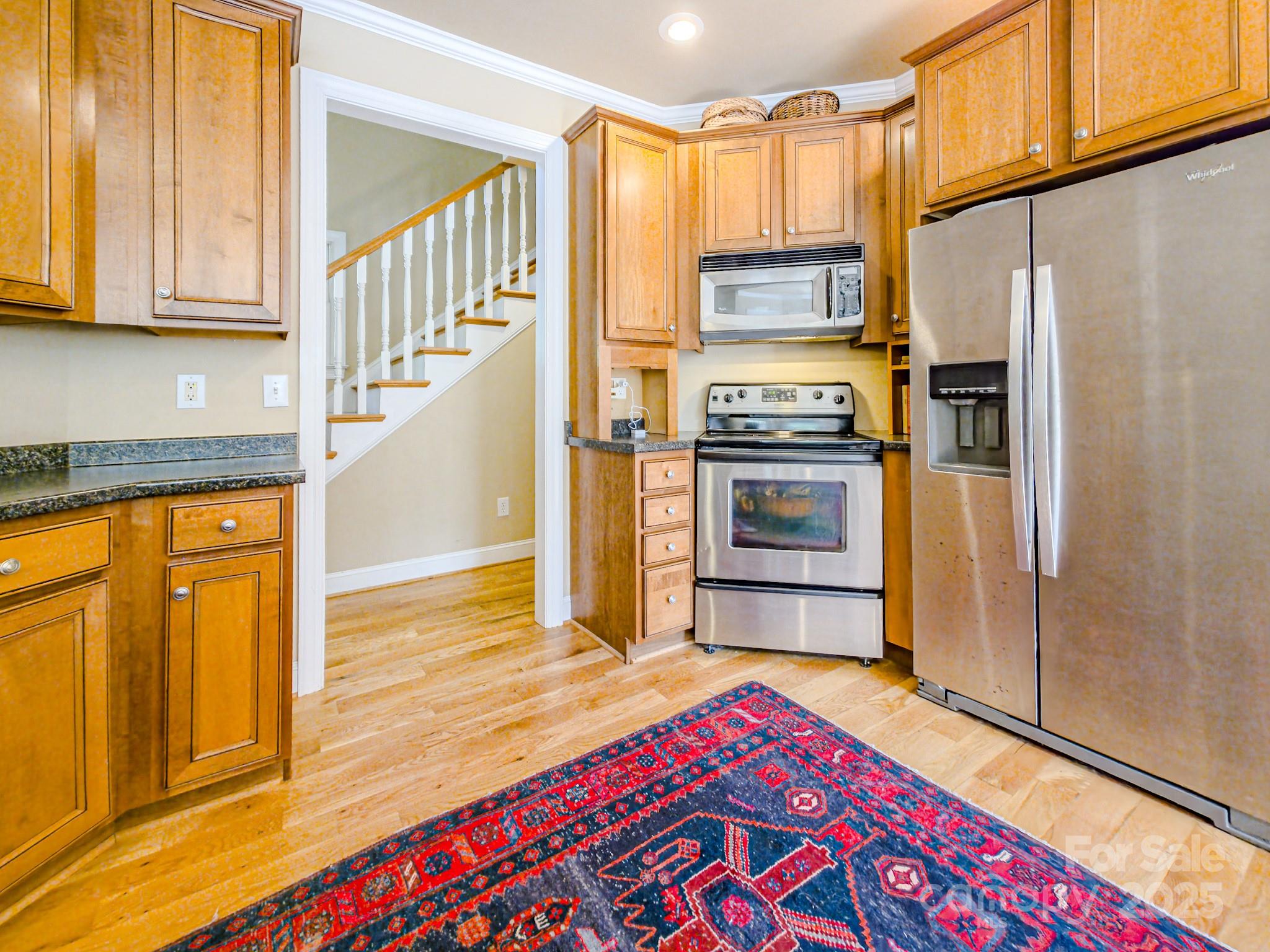 196 Col Hamptons Court Rutherfordton, NC 28139 - Photo 11 of 47 a kitchen with granite countertop a refrigerator stove and cabinets