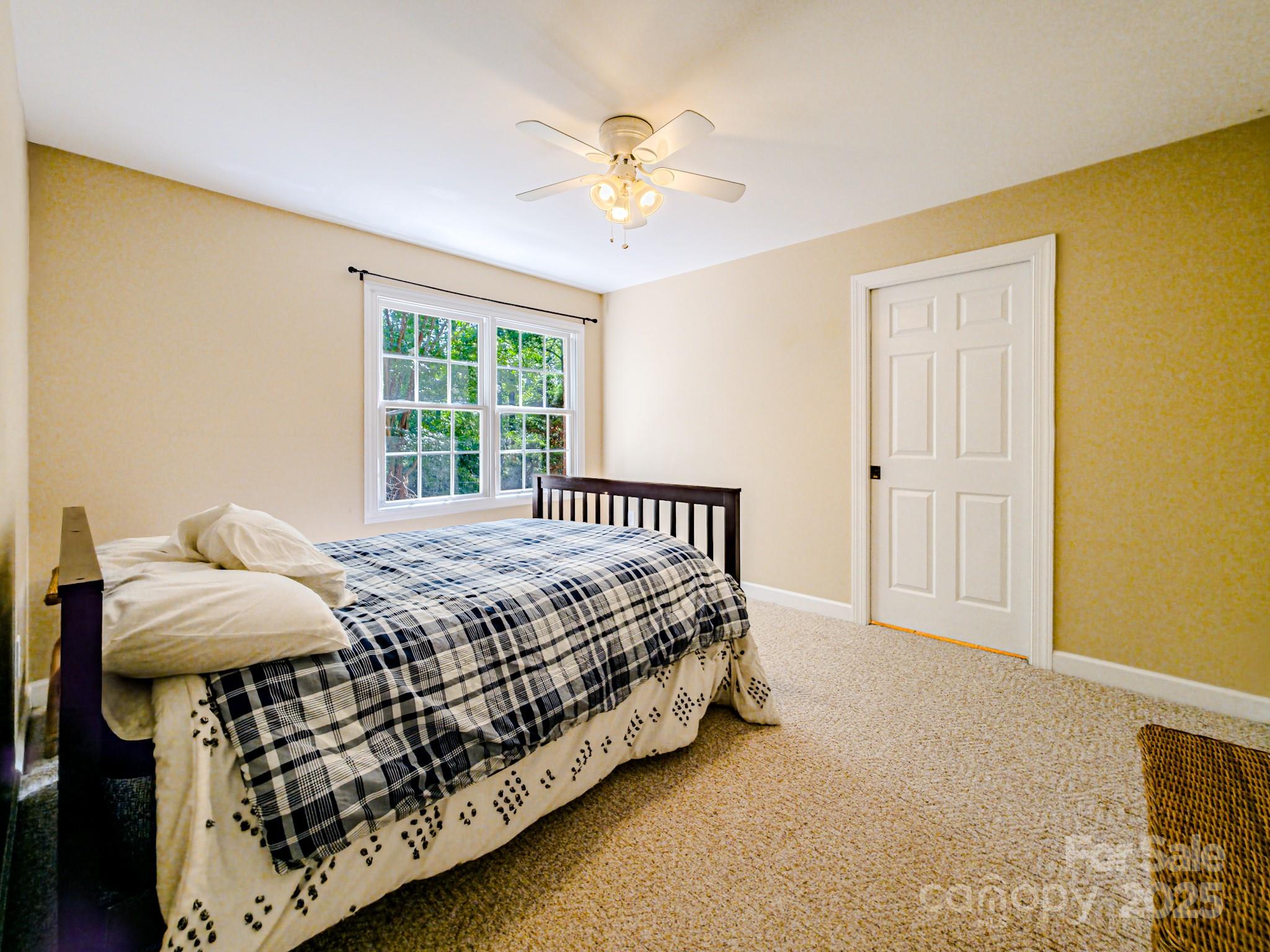 196 Col Hamptons Court Rutherfordton, NC 28139 - Photo 35 of 47 a bed sitting in a bedroom next to a window