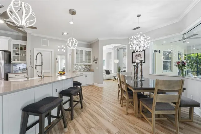a view of a dining room with furniture and chandelier