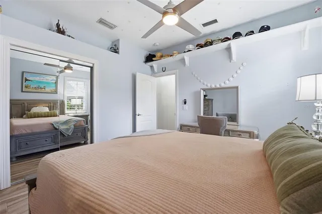 a bedroom with a large bed and a large mirror