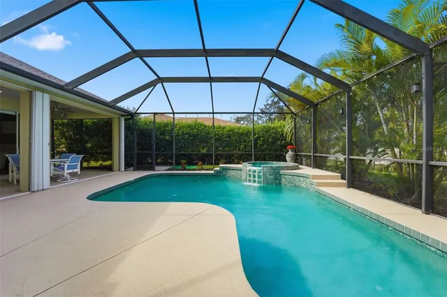 a view of a patio with a table and chairs under an umbrella