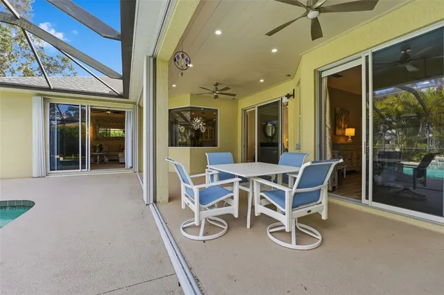 a view of a park with potted plants and large trees