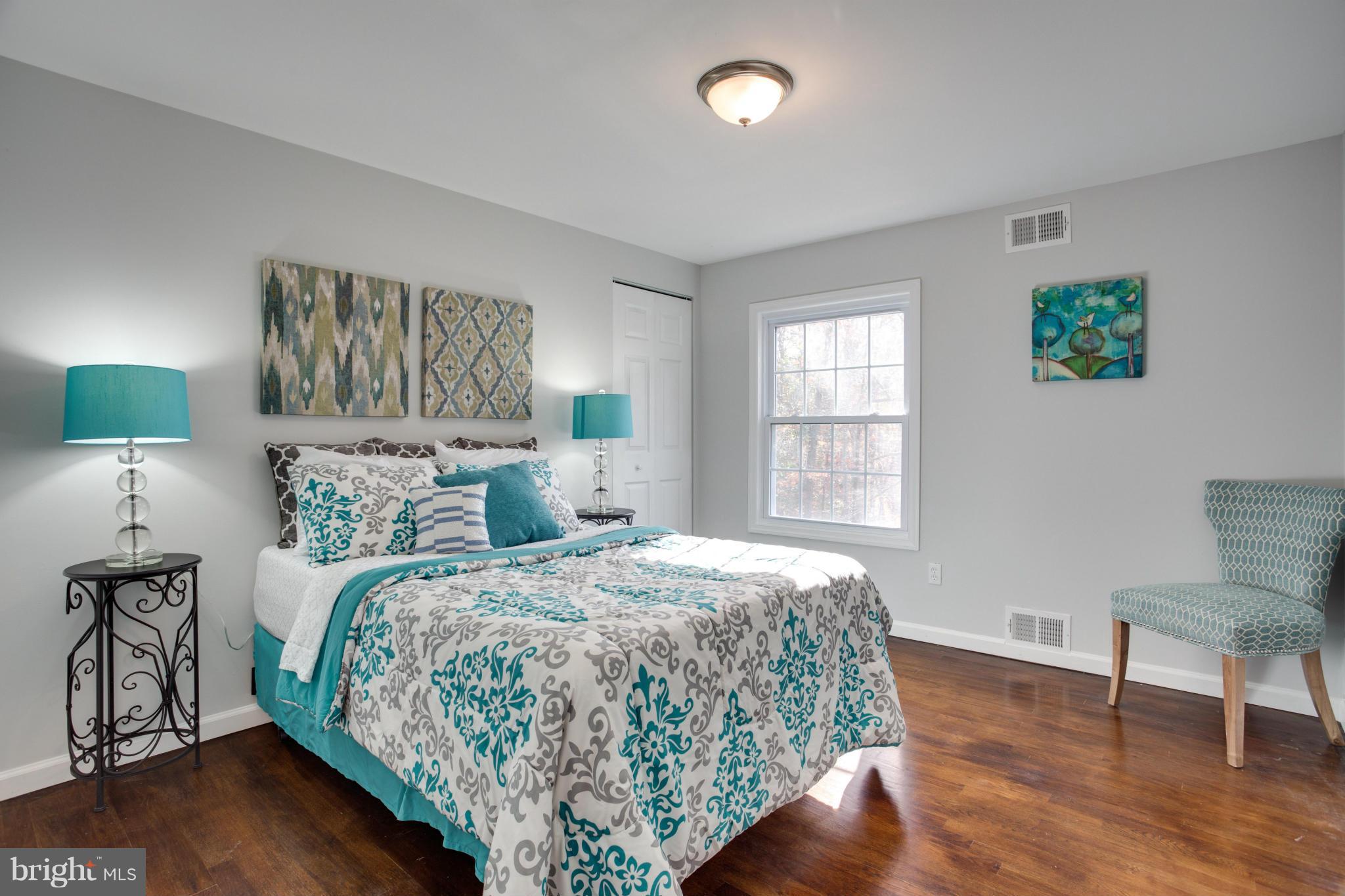 602 Pine Road Fort Washington, MD 20744 - Photo 22 of 30 a bedroom with a bed and a lamp