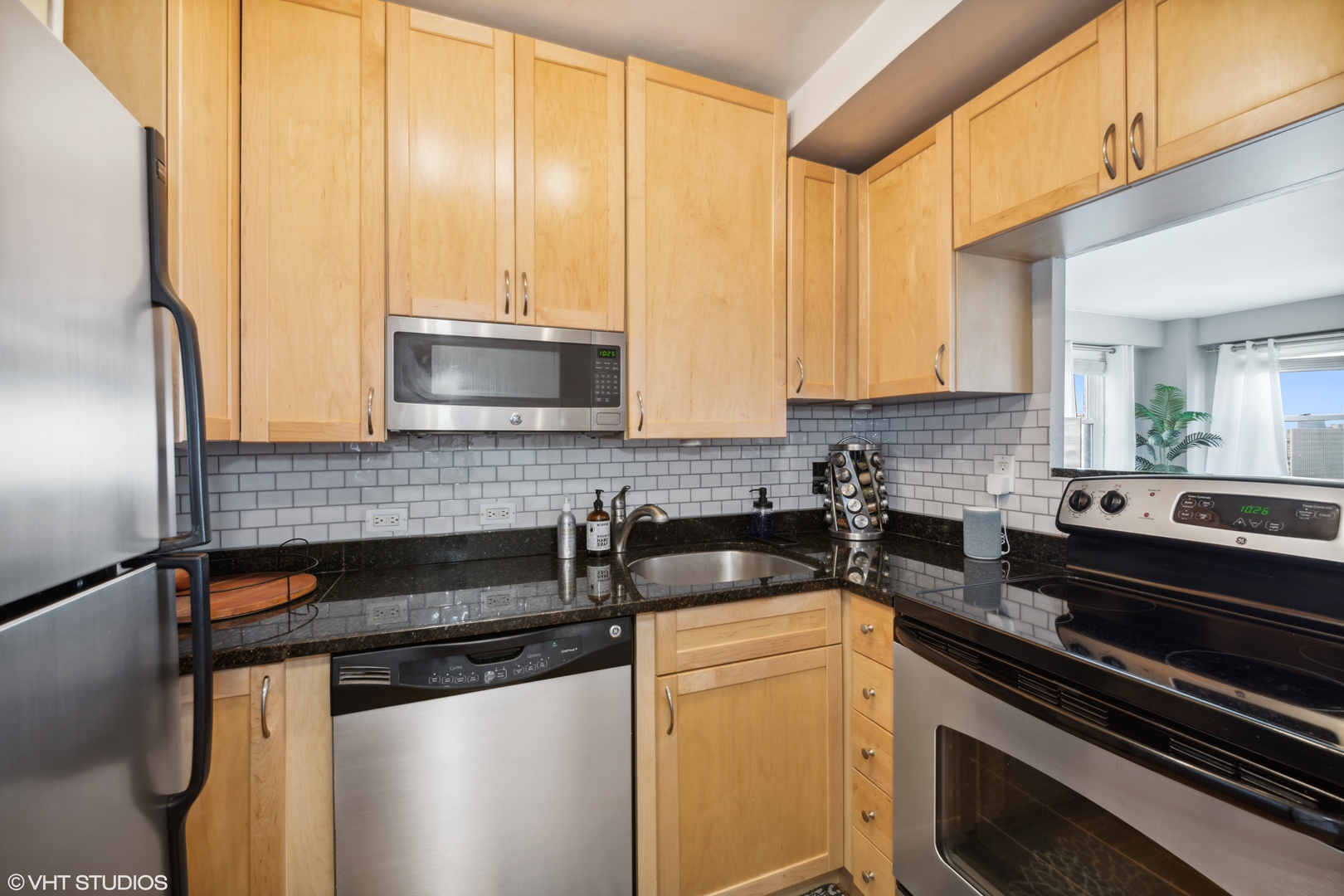 2909 North Sheridan Road, Unit 1711 Chicago, IL 60657 - Photo 7 of 14 a kitchen with stainless steel appliances a sink stove and cabinets