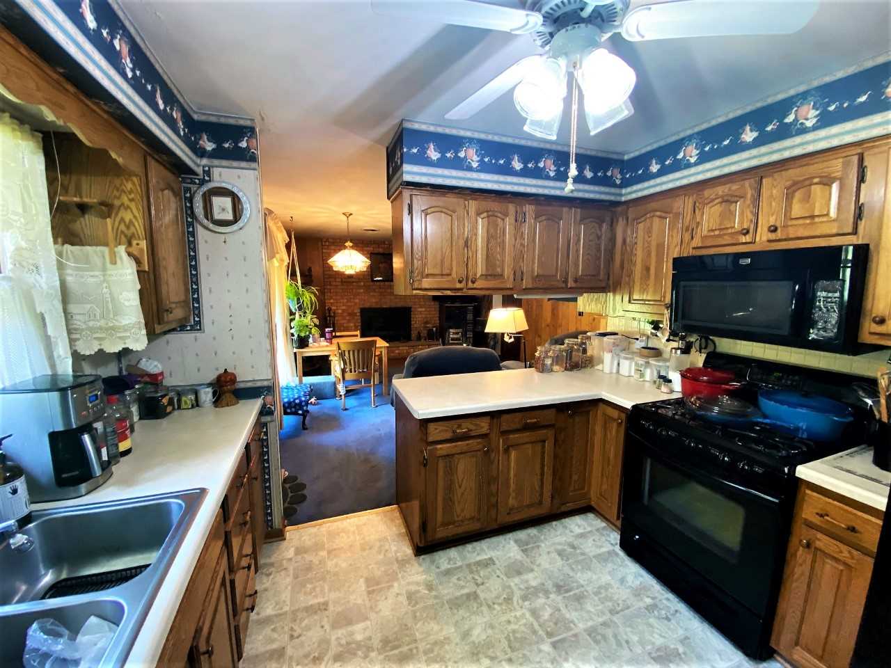 110 Lovesee Road Roscoe, IL 61073 - Photo 14 of 25 a kitchen with a stove and a sink