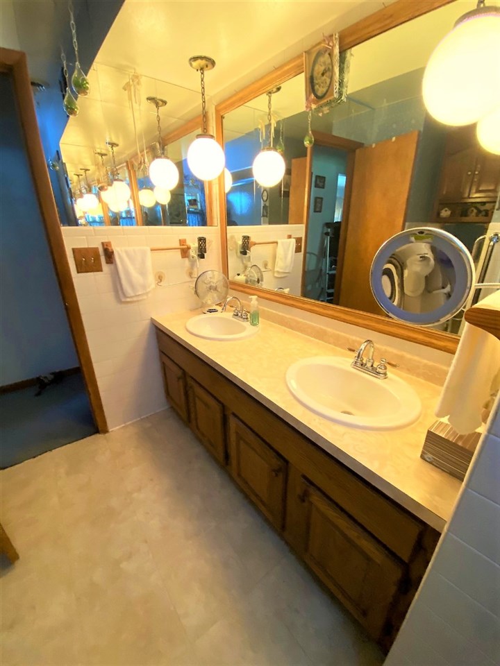 110 Lovesee Road Roscoe, IL 61073 - Photo 20 of 25 a bathroom with a sink and a mirror