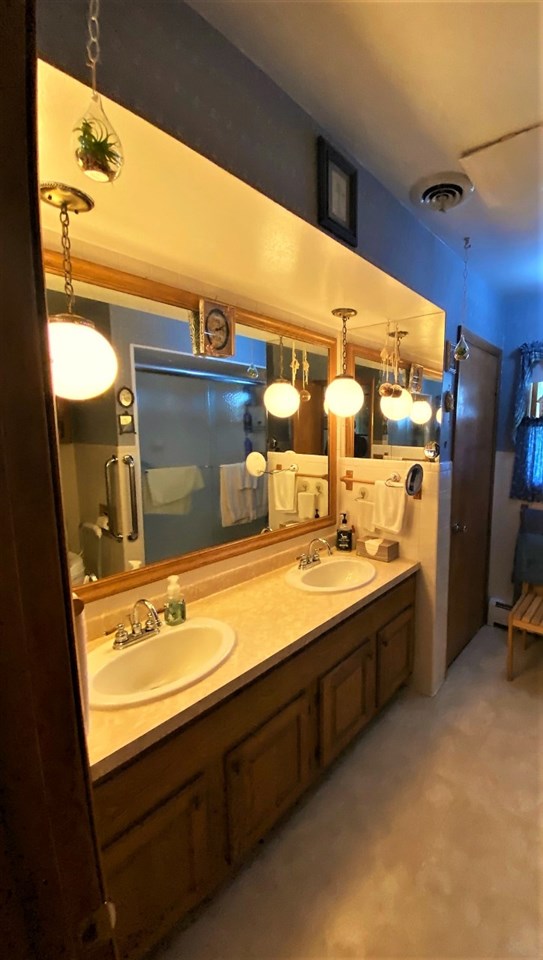 110 Lovesee Road Roscoe, IL 61073 - Photo 21 of 25 a bathroom with a double vanity sink and a mirror