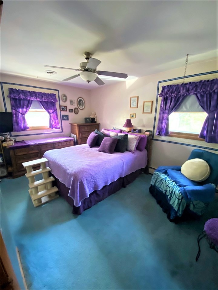 110 Lovesee Road Roscoe, IL 61073 - Photo 24 of 25 a spacious bedroom with a bed and a chandelier