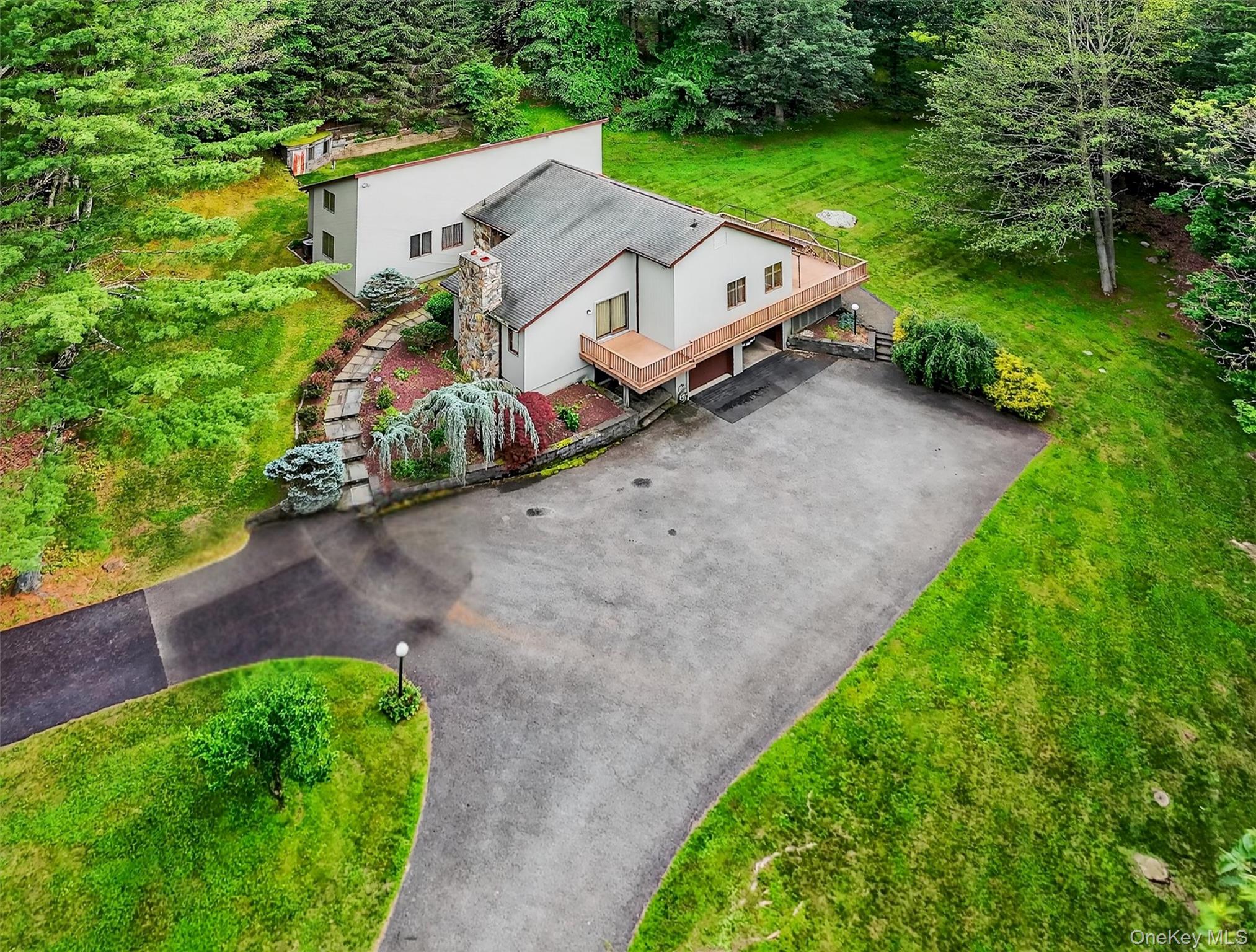 an aerial view of a house with garden space and street view