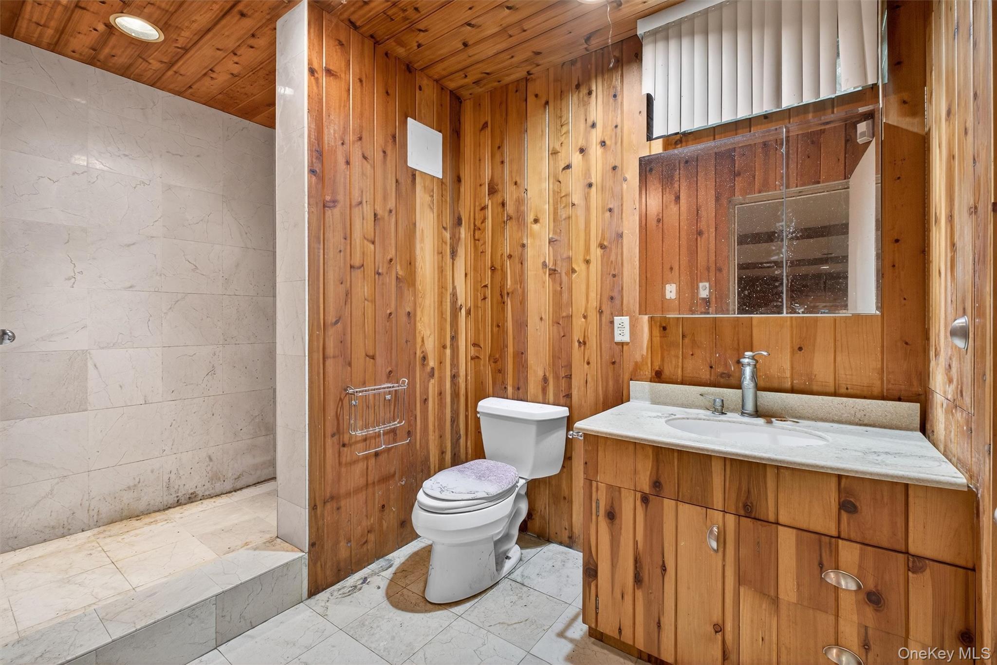 35 Greenlawn Road Amawalk, NY 10501 - Photo 31 of 50 a bathroom with a granite countertop sink a toilet a mirror and shower