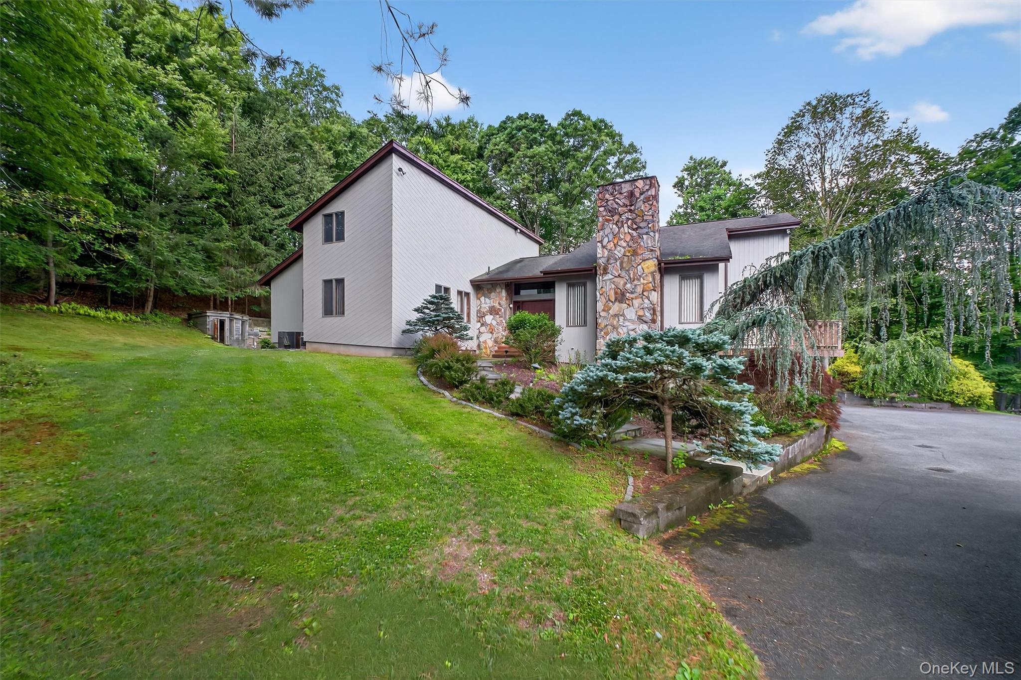 35 Greenlawn Road Amawalk, NY 10501 - Photo 41 of 50 a view of a house with a yard and potted plants