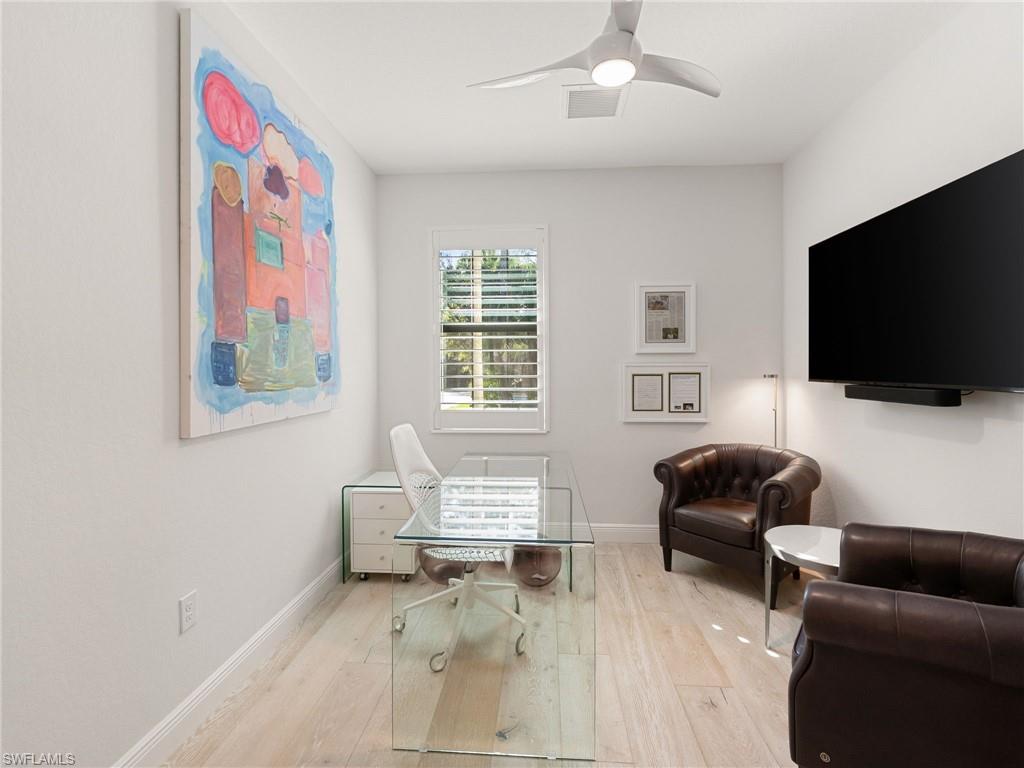 4199 11th Avenue Southwest Naples, FL 34116 - Photo 12 of 36 a living room with furniture and a flat screen tv