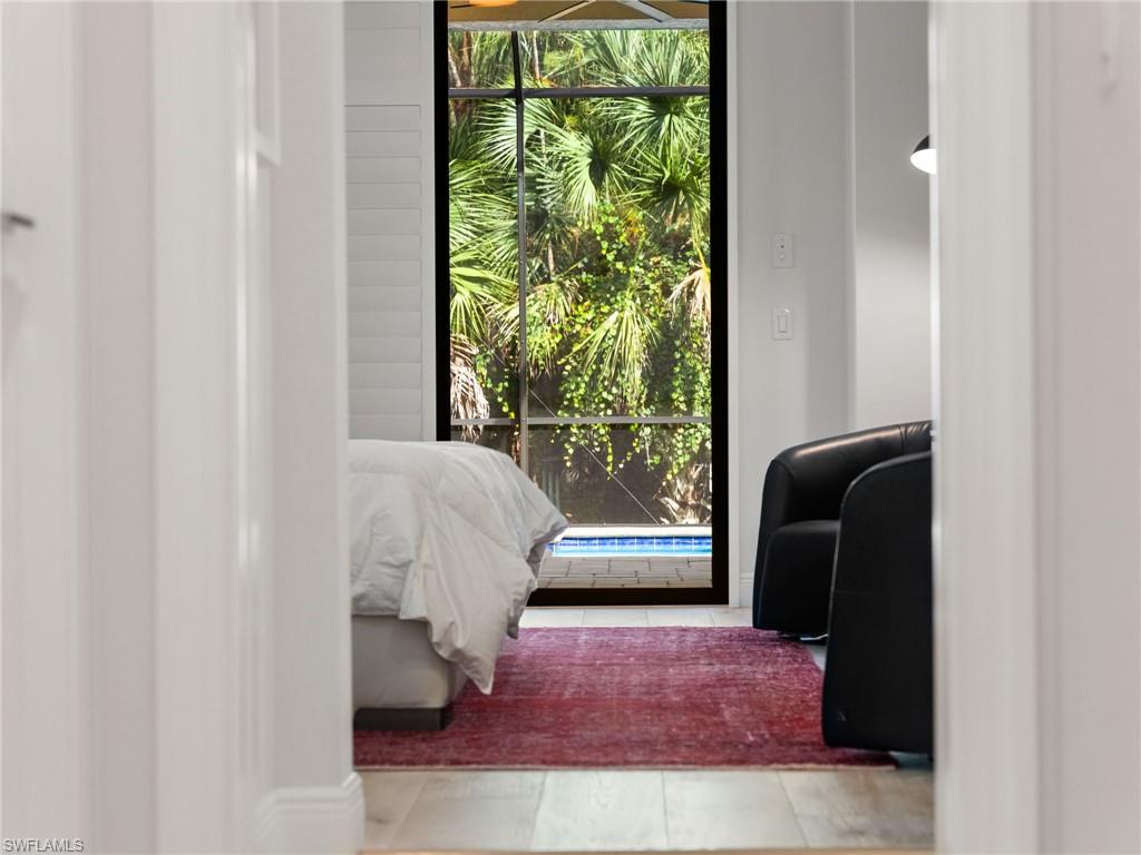 4199 11th Avenue Southwest Naples, FL 34116 - Photo 21 of 36 a living room with furniture and a window