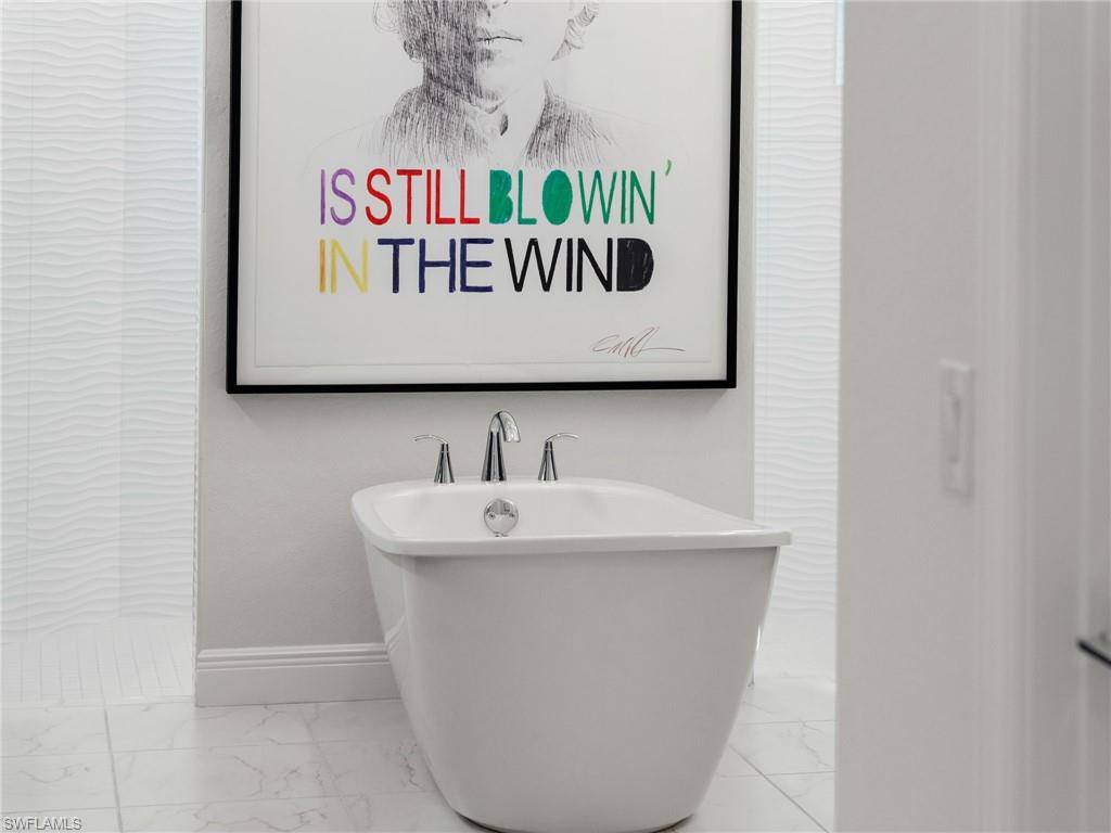 4199 11th Avenue Southwest Naples, FL 34116 - Photo 25 of 36 a bathroom with a sink and a white cabinet