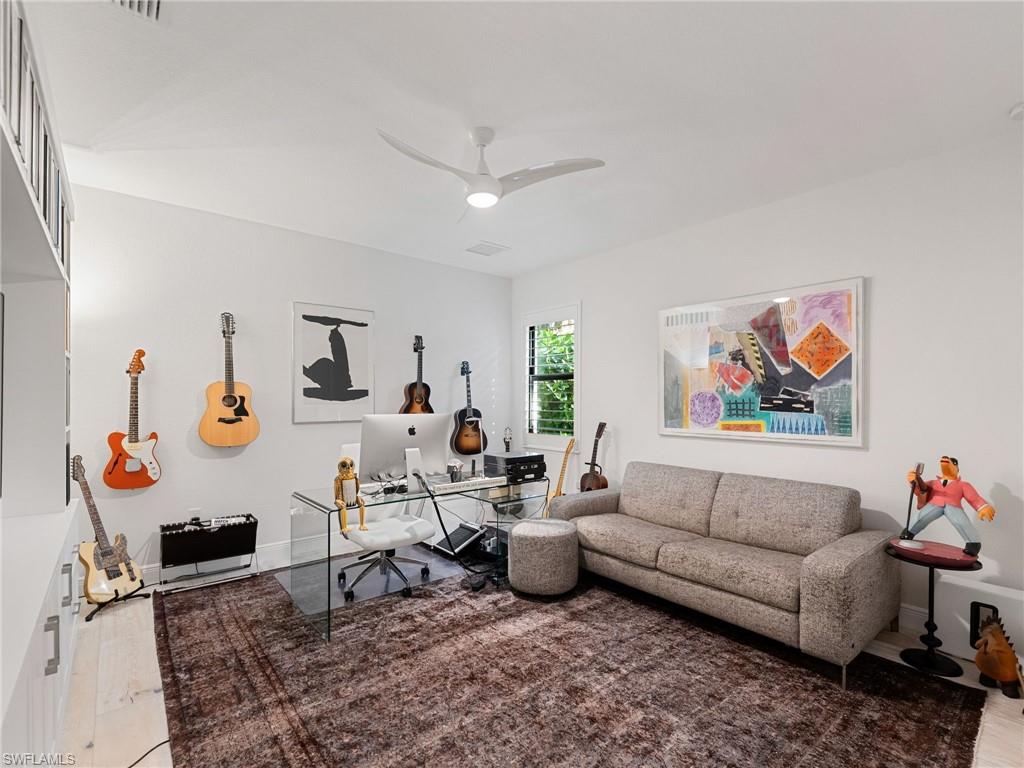 4199 11th Avenue Southwest Naples, FL 34116 - Photo 27 of 36 a living room with furniture and a couch