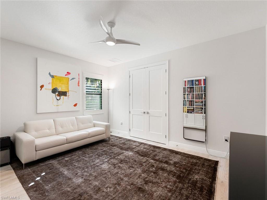 4199 11th Avenue Southwest Naples, FL 34116 - Photo 30 of 36 a living room with furniture and a rug