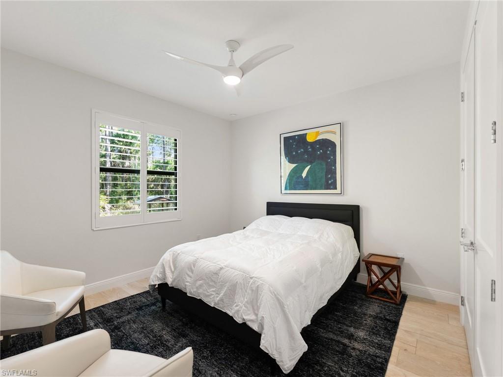 4199 11th Avenue Southwest Naples, FL 34116 - Photo 32 of 36 a bedroom with a bed and a painting on the wall