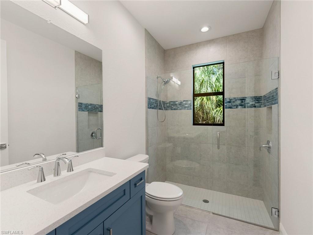 4199 11th Avenue Southwest Naples, FL 34116 - Photo 33 of 36 a bathroom with a sink a toilet and shower