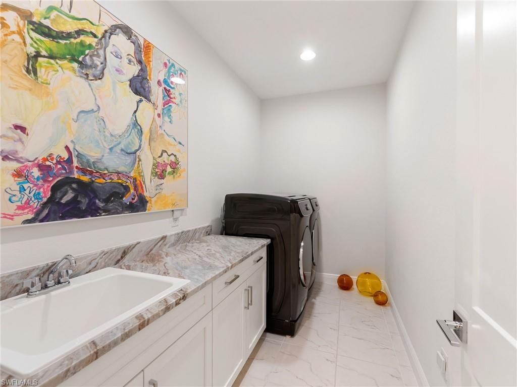 4199 11th Avenue Southwest Naples, FL 34116 - Photo 34 of 36 a bathroom with a sink and a tub