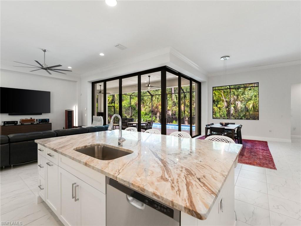 4199 11th Avenue Southwest Naples, FL 34116 - Photo 7 of 36 a large white kitchen with a large window
