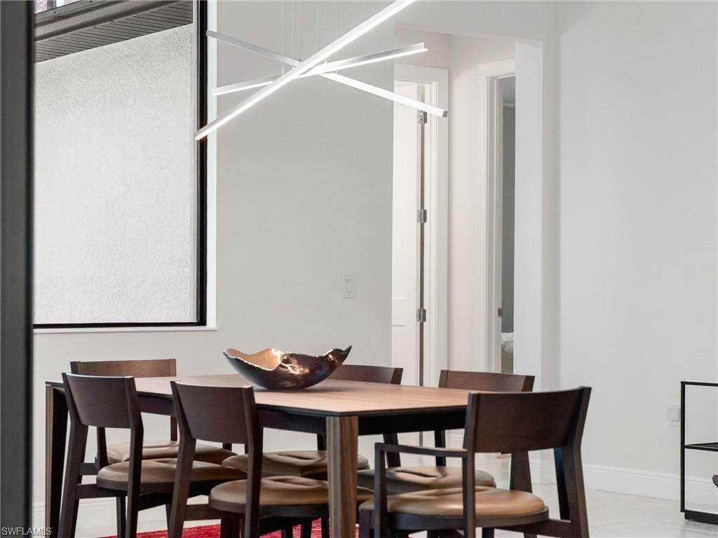 4199 11th Avenue Southwest Naples, FL 34116 - Photo 8 of 36 a view of a dining room with furniture