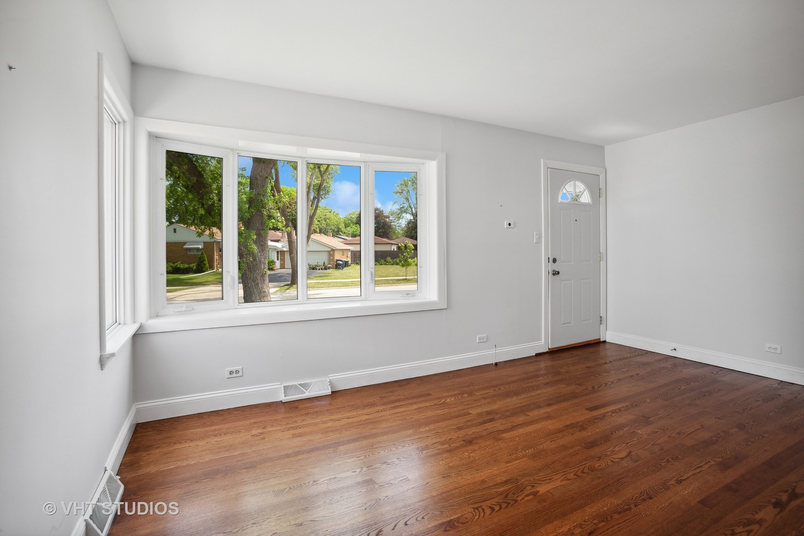 556 Pinehurst Drive Des Plaines, IL 60016 - Photo 3 of 18 a view of an empty room with wooden floor and a window