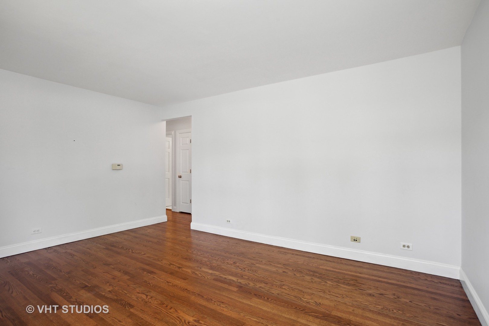 556 Pinehurst Drive Des Plaines, IL 60016 - Photo 4 of 18 an empty room with wooden floor