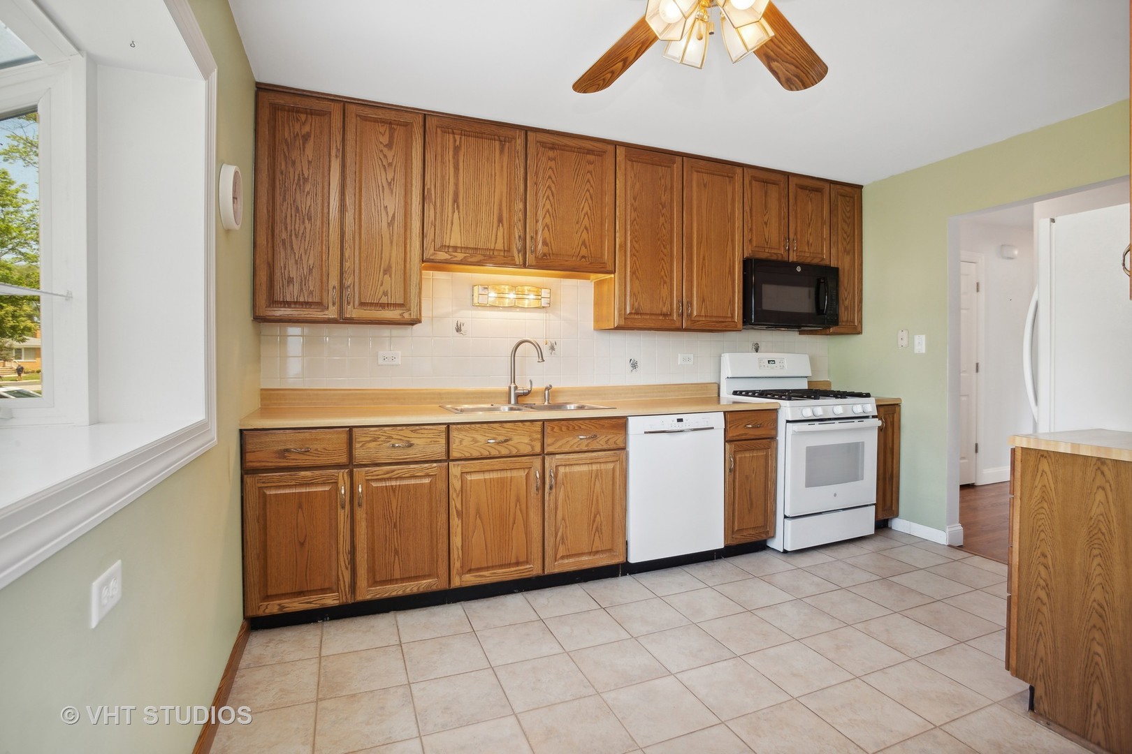556 Pinehurst Drive Des Plaines, IL 60016 - Photo 5 of 18 a kitchen with a sink cabinets and window