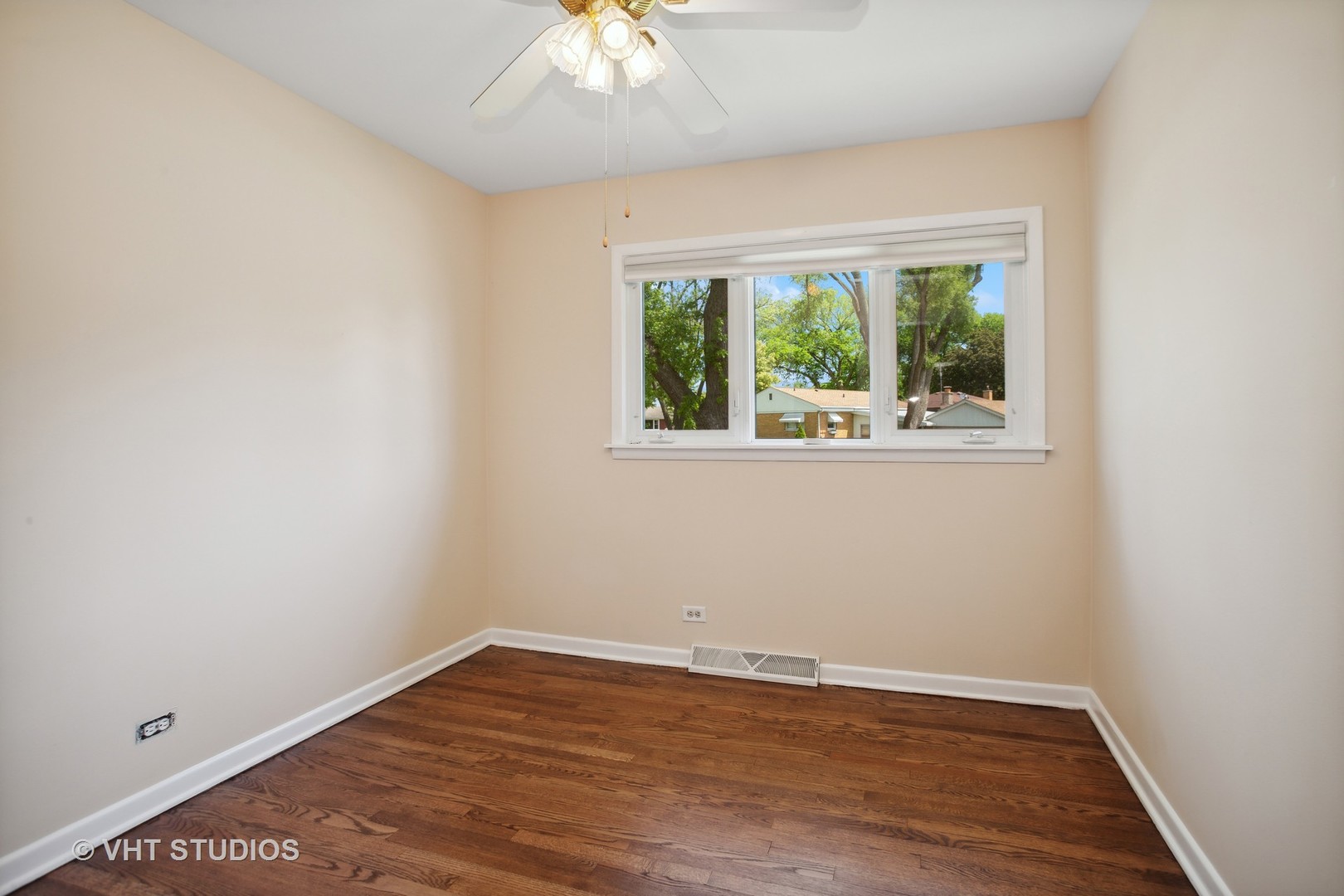 556 Pinehurst Drive Des Plaines, IL 60016 - Photo 9 of 18 an empty room with wooden floor and windows